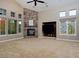 Spacious living room with a stone fireplace and large windows for natural light at 14022 E Fair Pl, Centennial, CO 80111