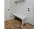 Mudroom features a white bench and storage hooks for organizing at 14022 E Fair Pl, Centennial, CO 80111