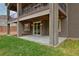 Covered patio area with concrete slab and walk-out access to the backyard at 14022 E Fair Pl, Centennial, CO 80111