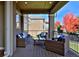 Cozy covered patio with wicker furniture and outdoor seating area at 14022 E Fair Pl, Centennial, CO 80111