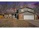 Charming two-story home with a brick and siding facade, a blue front door, and an attached two-car garage at 6844 Urban St, Arvada, CO 80004