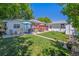 Spacious backyard with lush green grass and an outdoor dining area at 1922 Graves Ct, Northglenn, CO 80233