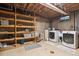 Utility basement featuring shelving, a washer, and a dryer at 1922 Graves Ct, Northglenn, CO 80233