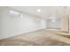 Large basement with carpet flooring and white walls, offering plenty of space for various uses at 1922 Graves Ct, Northglenn, CO 80233