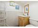 Well-lit half bathroom with a vanity, sink, mirror and toilet at 1922 Graves Ct, Northglenn, CO 80233
