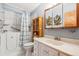 Bathroom with walk-in tub, custom storage, and a modern vanity at 1922 Graves Ct, Northglenn, CO 80233
