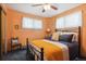 Inviting bedroom featuring a wrought iron bed frame, soft lighting and a cozy atmosphere at 1922 Graves Ct, Northglenn, CO 80233