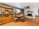 Cozy dining room featuring a stone accent wall, fireplace, and wooden furniture at 1922 Graves Ct, Northglenn, CO 80233