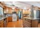 Bright kitchen with wood cabinets, island, granite counters, tile backsplash and stainless steel refrigerator at 1922 Graves Ct, Northglenn, CO 80233