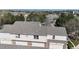 Aerial view showcasing the well-maintained roofs, garages, and the surrounding suburban landscape with a view of mountains at 1381 W 112Th Ave # B, Westminster, CO 80234