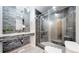 Modern bathroom featuring stone wall accents, tiled floors, a glass shower, and a contemporary design at 1381 W 112Th Ave # B, Westminster, CO 80234