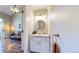 Charming half-bathroom with a circular mirror, a pedestal sink, modern vanity, and stylish fixtures and lighting at 1381 W 112Th Ave # B, Westminster, CO 80234