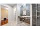 Modern bathroom featuring stone wall accents, tiled floors, a glass shower, and a contemporary design at 1381 W 112Th Ave # B, Westminster, CO 80234