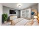 Bright bedroom featuring a large window, wood accents, a ceiling light, and an area rug at 1381 W 112Th Ave # B, Westminster, CO 80234
