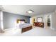 Spacious bedroom featuring a window, carpeted floors, neutral wall color, and an ensuite bathroom at 1381 W 112Th Ave # B, Westminster, CO 80234