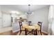 Cozy dining area with modern chandelier, seating for four, and adjacent to the kitchen at 1381 W 112Th Ave # B, Westminster, CO 80234