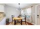 Dining area with modern chandelier, seating for four, natural light, and wine storage at 1381 W 112Th Ave # B, Westminster, CO 80234