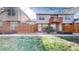 Charming townhome exterior with red door, small balcony and a well-kept lawn and walkway to the entrance at 1381 W 112Th Ave # B, Westminster, CO 80234