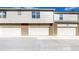 Row of attached garages with brick accents, offering ample parking and storage, and creating a cohesive street view at 1381 W 112Th Ave # B, Westminster, CO 80234
