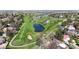 Aerial view of lush golf course, pond, and surrounding neighborhood at 1381 W 112Th Ave # B, Westminster, CO 80234