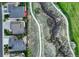 An aerial view of several homes including their yards and sidewalks and a green walking path at 1497 Bent Grass Cir, Castle Rock, CO 80109