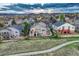 A lovely two story home featuring a raised deck, with landscaping and mature trees surrounding the home at 1497 Bent Grass Cir, Castle Rock, CO 80109