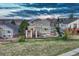 A lovely two story home featuring a raised deck, with landscaping and mature trees surrounding the home at 1497 Bent Grass Cir, Castle Rock, CO 80109
