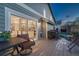 Relaxing back porch with outdoor seating, a grill, and a view into the home's kitchen at 1497 Bent Grass Cir, Castle Rock, CO 80109