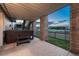 Covered patio with a hot tub and views of the lawn and neighborhood beyond the fence at 1497 Bent Grass Cir, Castle Rock, CO 80109