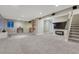 Spacious basement with neutral carpet, built-in shelves, a fireplace, and stairs to the upper level at 1497 Bent Grass Cir, Castle Rock, CO 80109