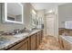 Bathroom with double sink vanity, granite countertops, and stylish tile floors at 1497 Bent Grass Cir, Castle Rock, CO 80109