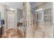 Modern bathroom with tiled shower, soaking tub, and glass enclosure at 1497 Bent Grass Cir, Castle Rock, CO 80109