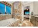 Bathroom featuring a luxurious tub, shower, and stylish tile accents at 1497 Bent Grass Cir, Castle Rock, CO 80109