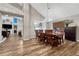 Open concept dining room and living room with wood floors, modern lighting and a rustic dining set at 1497 Bent Grass Cir, Castle Rock, CO 80109