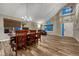 Open concept dining room and living room featuring lots of light, vaulted ceilings, and wood floors at 1497 Bent Grass Cir, Castle Rock, CO 80109