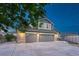 Beautiful two-story home showcasing a spacious driveway, three-car garage and lovely curb appeal at 1497 Bent Grass Cir, Castle Rock, CO 80109