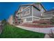 Exterior view of a two-story home with a walk-up staircase and landscaped backyard at 1497 Bent Grass Cir, Castle Rock, CO 80109