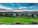 Beautiful homes overlook a manicured green space with blue skies and mountain views in the distance at 1497 Bent Grass Cir, Castle Rock, CO 80109