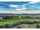 A view of a grassy area with homes in the distance in front of a stunning mountain range at 1497 Bent Grass Cir, Castle Rock, CO 80109
