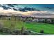 A view of a green space, featuring a walking path and neighborhood homes in the background at 1497 Bent Grass Cir, Castle Rock, CO 80109