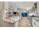 Spacious open-concept kitchen featuring stainless appliances, a large island, and vaulted ceilings at 1497 Bent Grass Cir, Castle Rock, CO 80109