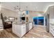 Spacious open-concept kitchen featuring stainless appliances, a large island with seating, and a living area at 1497 Bent Grass Cir, Castle Rock, CO 80109