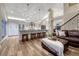 Open-concept kitchen and living area featuring stainless appliances, a large island, and a cozy leather sectional at 1497 Bent Grass Cir, Castle Rock, CO 80109