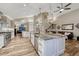 An open-concept kitchen featuring stainless appliances, a large island with bar seating, and a cozy living area at 1497 Bent Grass Cir, Castle Rock, CO 80109