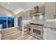 Well-lit kitchen with stainless steel appliances, white cabinets, granite counters, and a patterned backsplash at 1497 Bent Grass Cir, Castle Rock, CO 80109