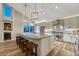 Large kitchen island featuring bar stool seating, stainless appliances, and hanging pendant lighting at 1497 Bent Grass Cir, Castle Rock, CO 80109