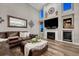 Cozy living room with a fireplace, high ceilings, and a comfortable leather sofa at 1497 Bent Grass Cir, Castle Rock, CO 80109