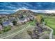 A view of homes near a walking path, green grass, and a large mountain in the background at 1497 Bent Grass Cir, Castle Rock, CO 80109