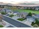An eye-level view of a gray home with a 3-car garage in a neighborhood near green golf course at 1497 Bent Grass Cir, Castle Rock, CO 80109