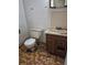 Bathroom showing a toilet and sink with a tiled floor and water stained walls at 18249 E Mexico Pl, Aurora, CO 80017
